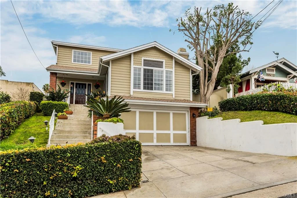 California real estate with beige walls and a driveway.