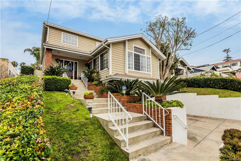 Luxury house California real estate with beige walls and a front porch.