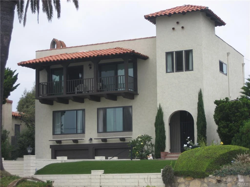 House in California real estate with tile roof, balconies, windows, and plants
