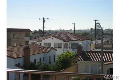 Residential buildings with tile roofs and telephone poles.