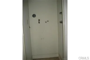 White door with doorknob and small holes.