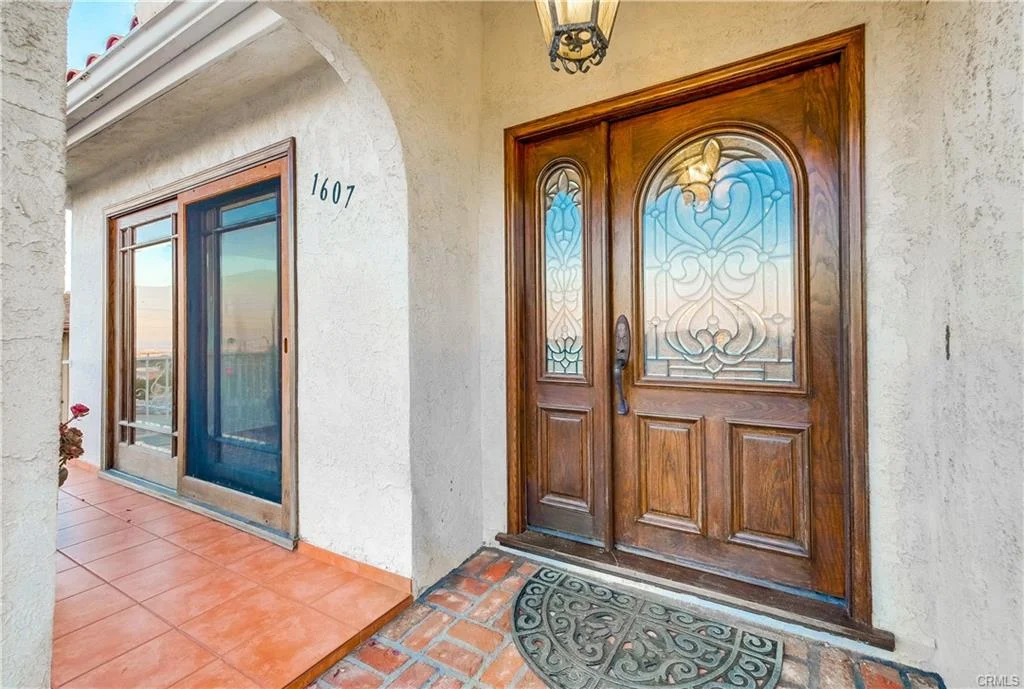 House in California real estate with double door, glass panels, and tile floor