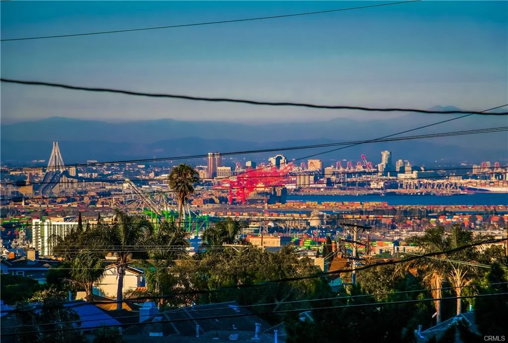 Cityscape with buildings, power lines, and harbor