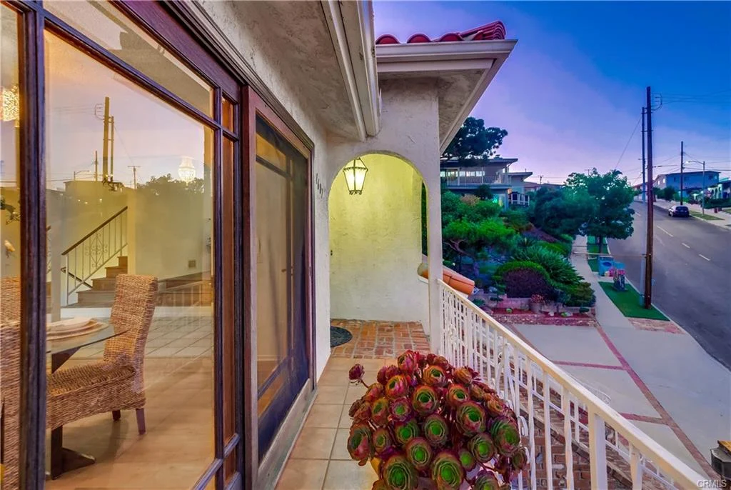 Patio view with plants, street, and exterior of house in California real estate
