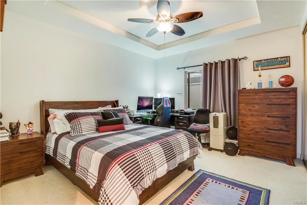 A bedroom with wooden furniture and a desk