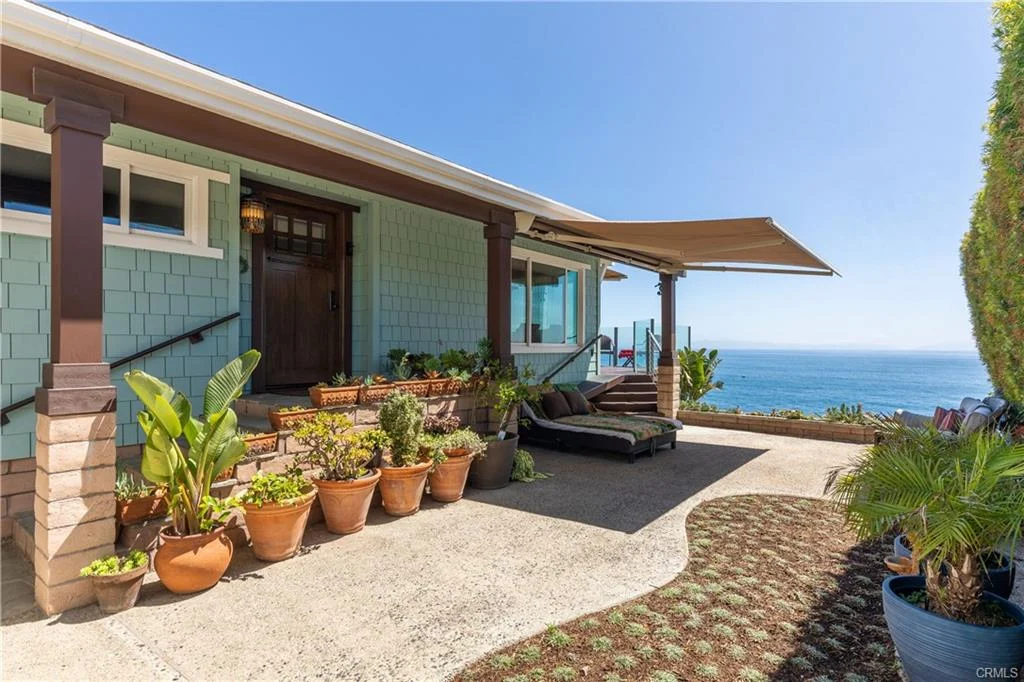 California real estate house with porch, plants, and ocean view