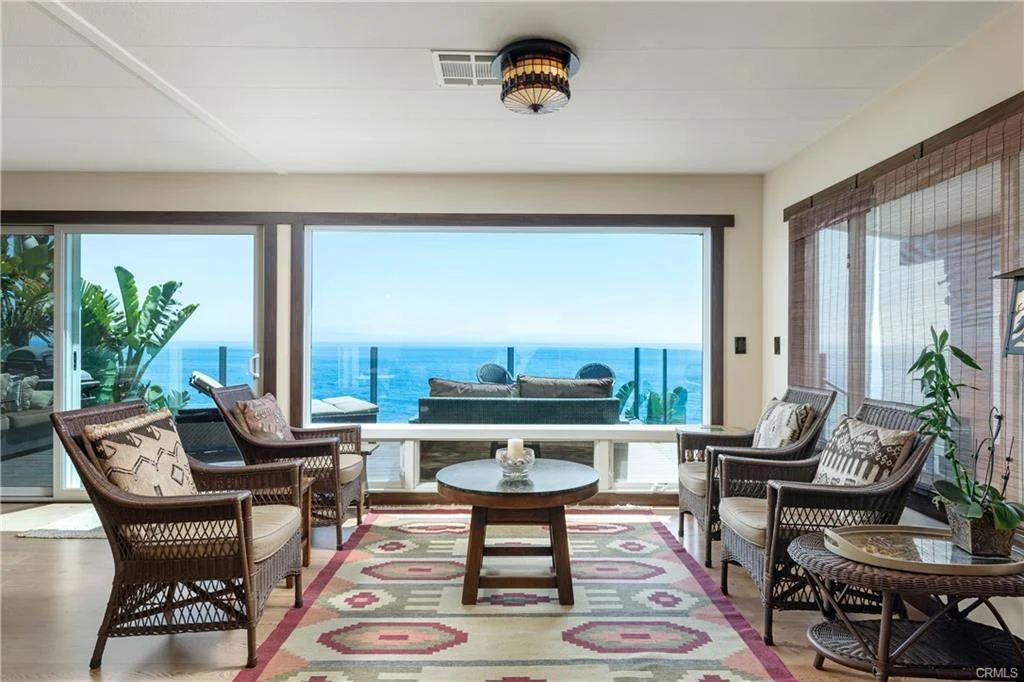 Living room with seating, rug, and ocean view