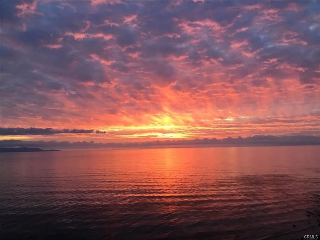 Ocean water with colorful sky and clouds