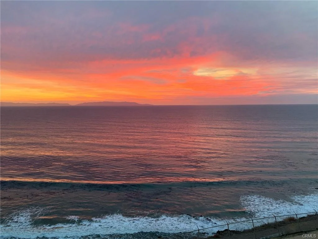 Ocean view from deck with clouds and islands