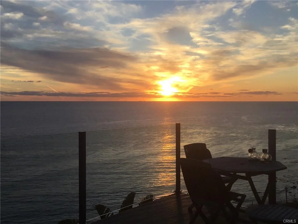Ocean view from deck with table and chair