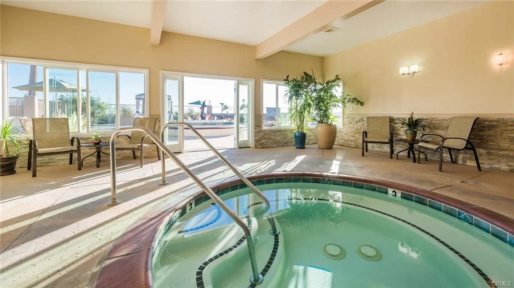 Indoor hot tub with seating and windows