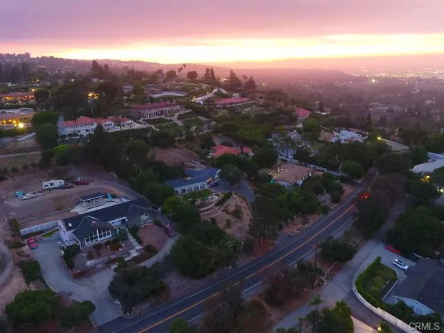 Aerial view of neighborhood with houses and roads in California real estate