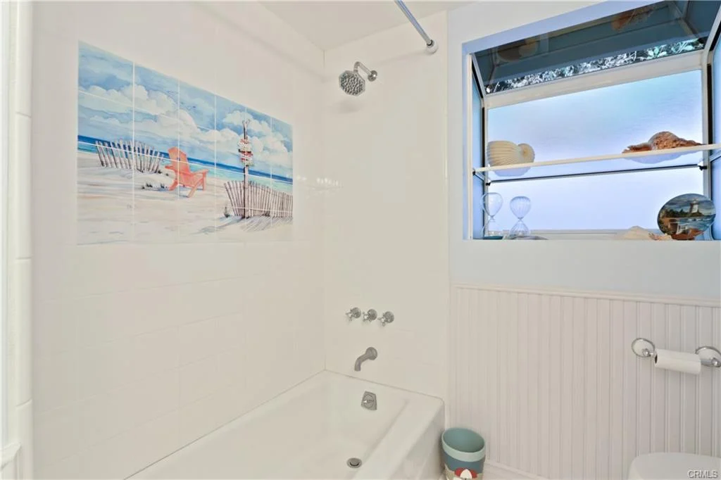 Bathroom with shower, bathtub, and decorative shelf.
