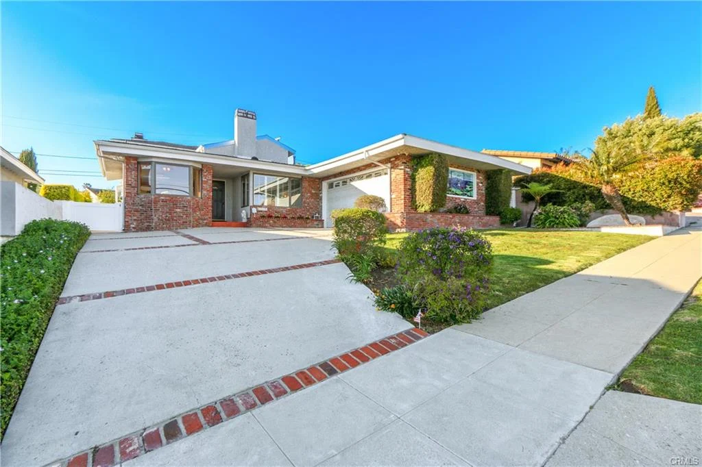 House with driveway and front lawn, California real estate.