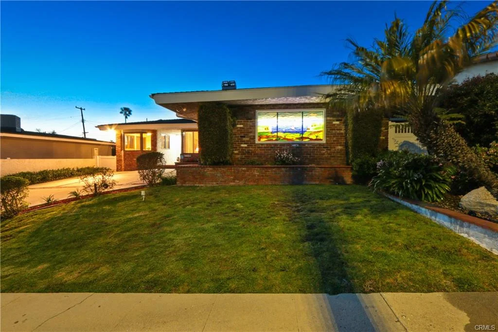 House with lawn and large window, California real estate.