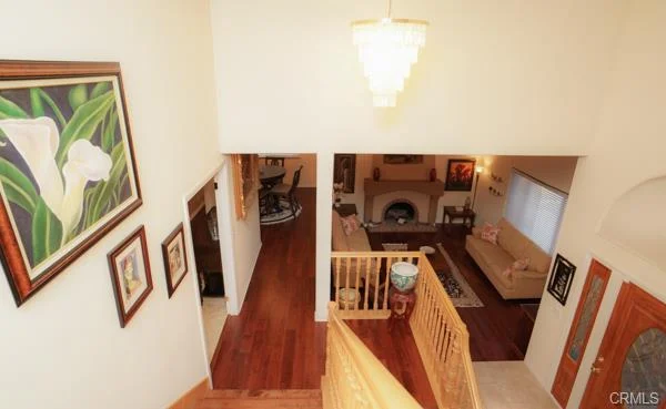Living room with a sofa, wooden floors, and artwork on the walls.