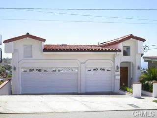 House in California real estate with tile roof, driveway, and garage