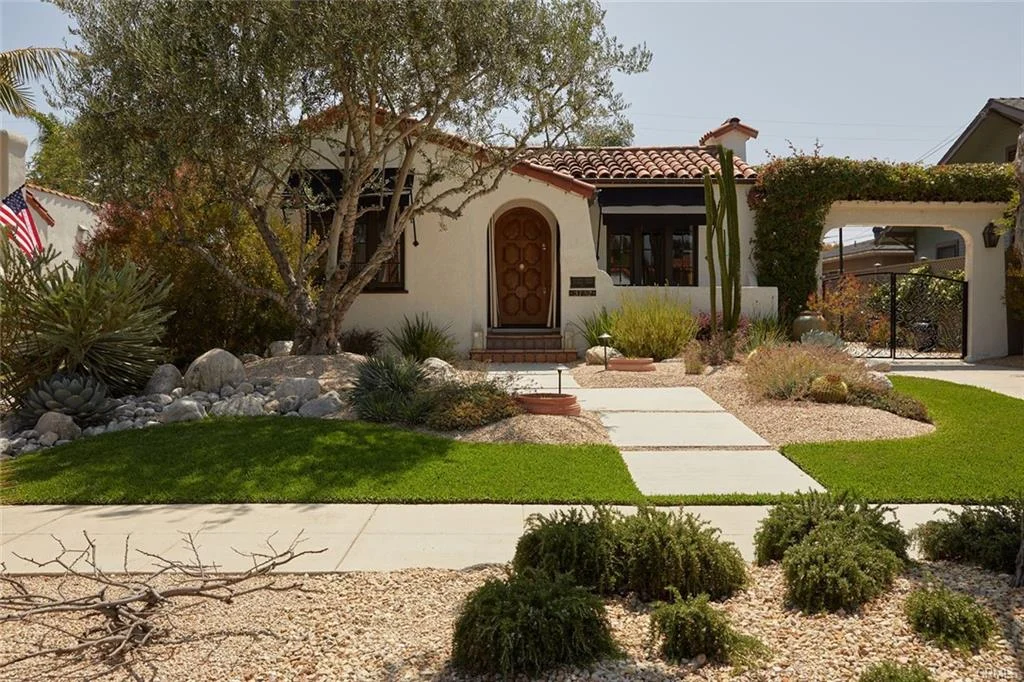 House in California real estate with red roof, lawn, pathway, and plants