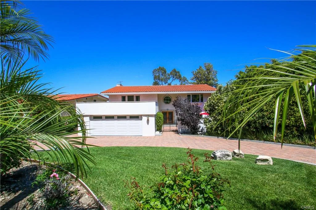 House with driveway and plants, California real estate.
