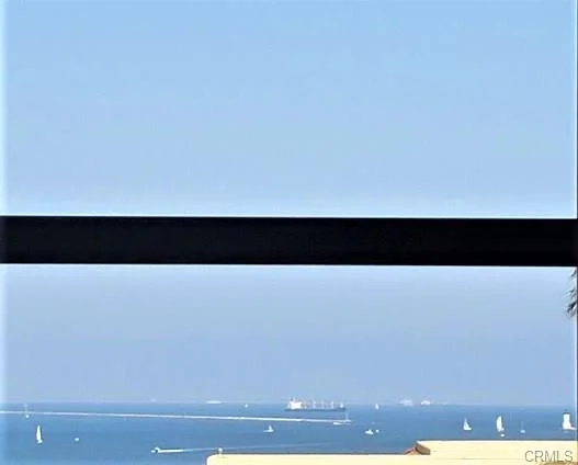 Ocean with sailboats and distant ship
