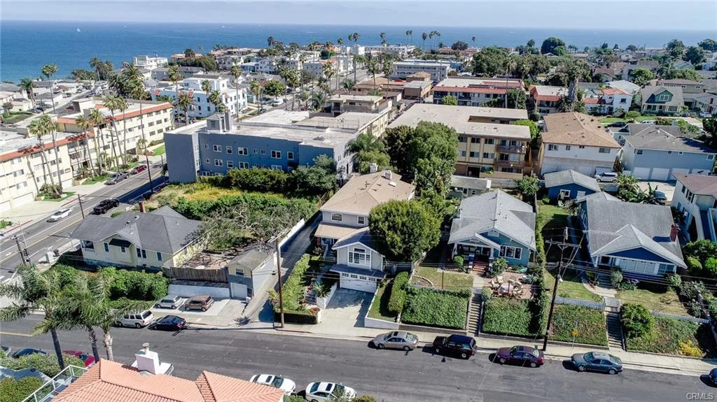 Coastal neighborhood with houses, streets, and ocean view