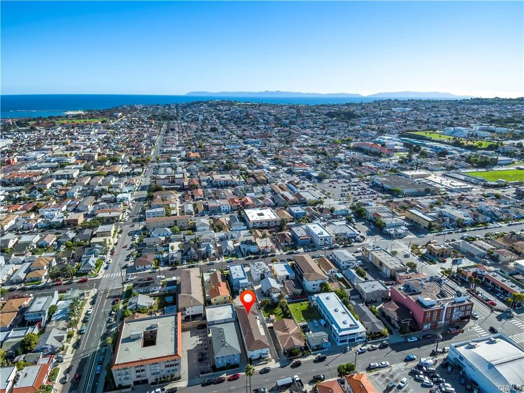 Aerial view of city with buildings, roads, and coastline