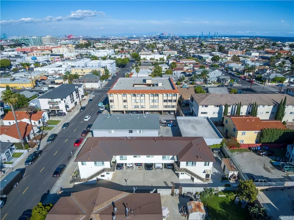 Aerial view of buildings with roofs and grass area with people