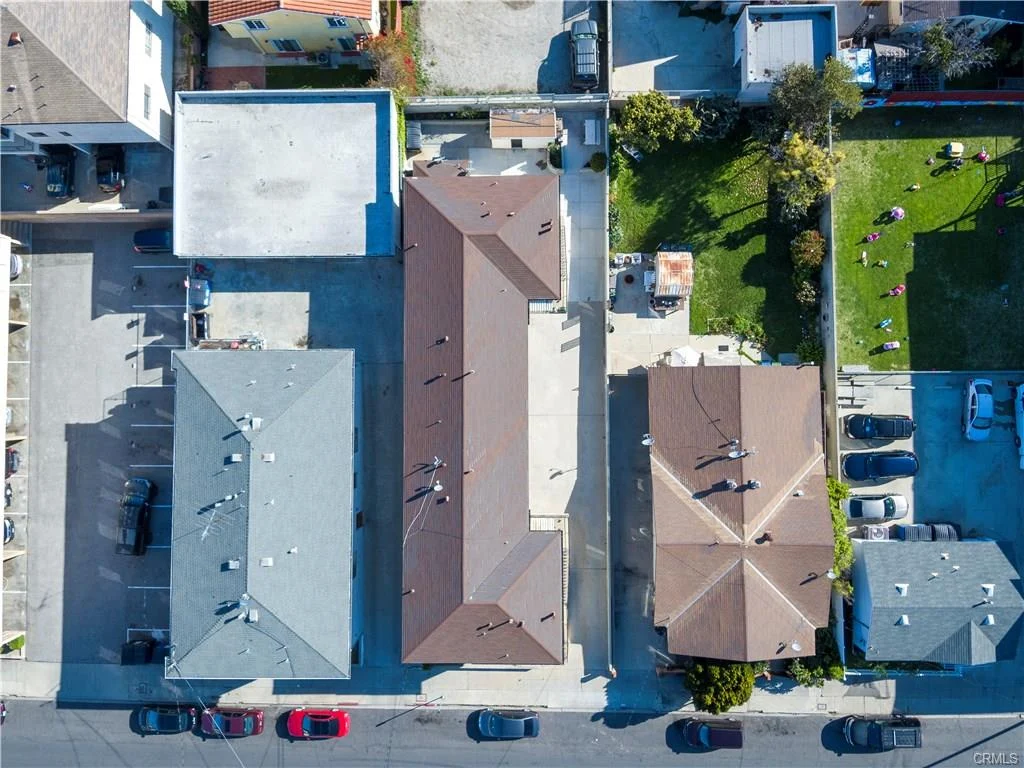 Aerial view of houses, streets, ocean, and buildings