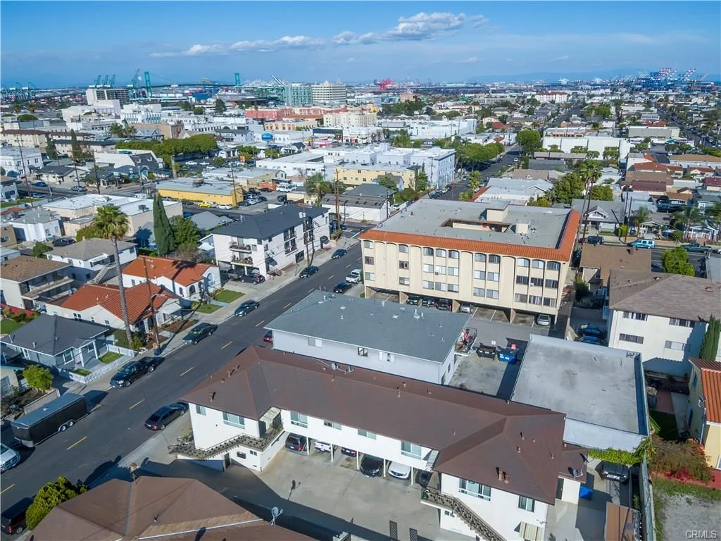 Aerial view of buildings with roofs and grass area with people
