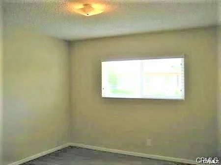 Empty room with light-colored walls and large window
